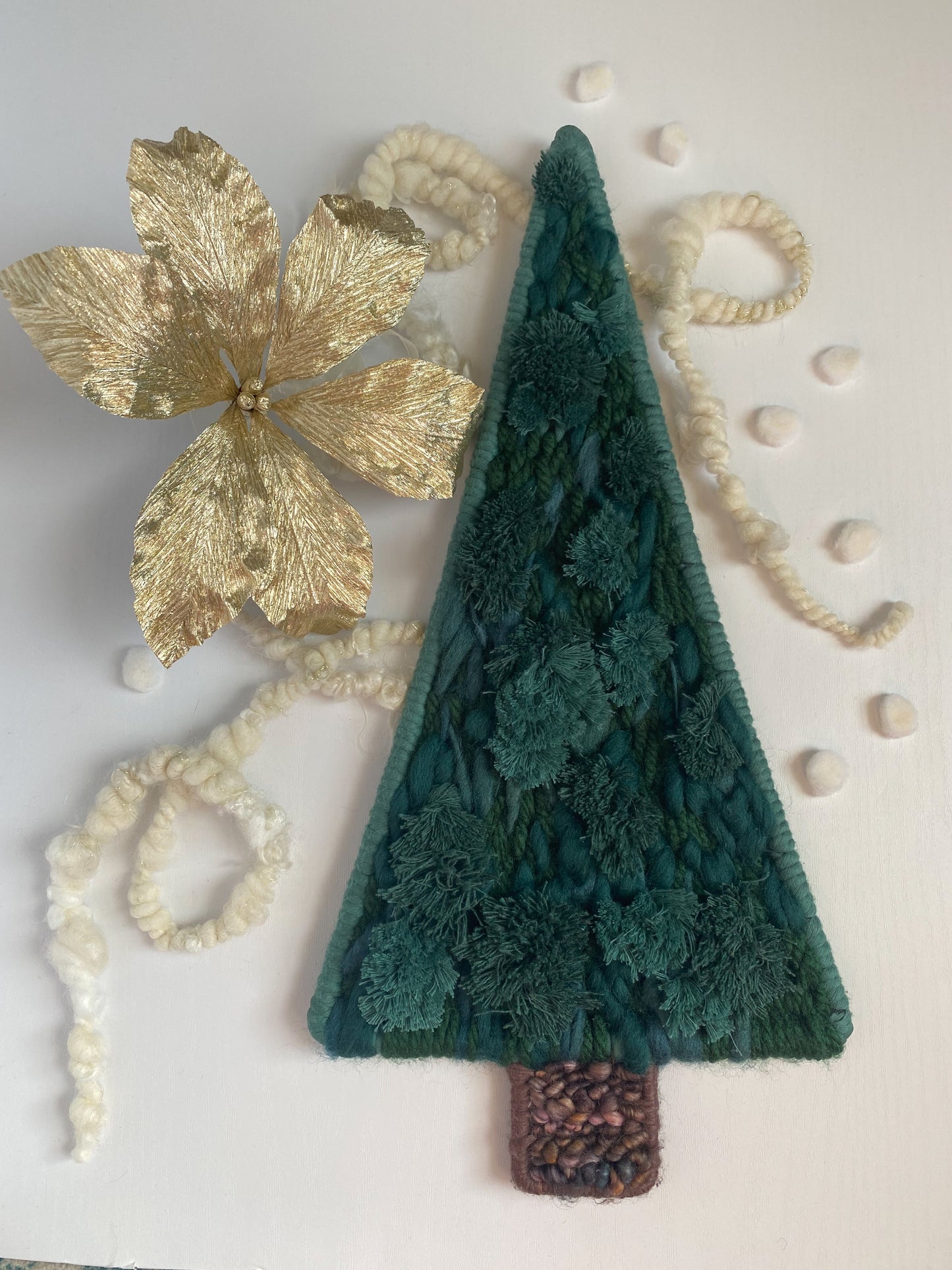 woven green pine tree with gold paper flower and handspun yarn backdrop